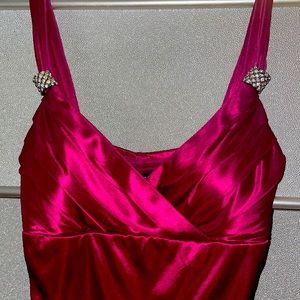 Magenta silk cocktail dress with diamond accents .